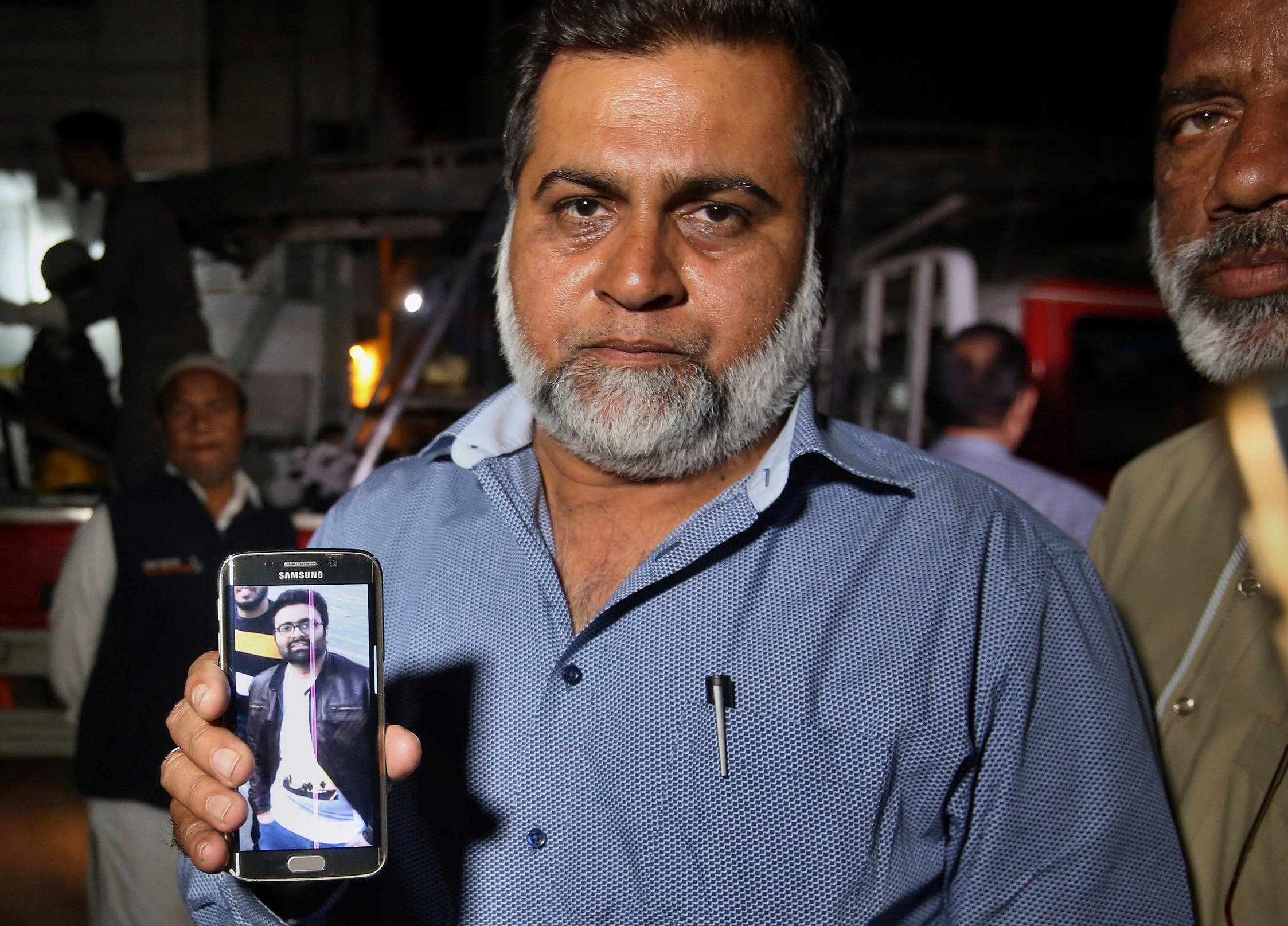 The uncle of Syed Areeb Ahmed, a Pakistani citizen who was killed the Christchurch mosque shooting, shows a photo of the accountant. 
