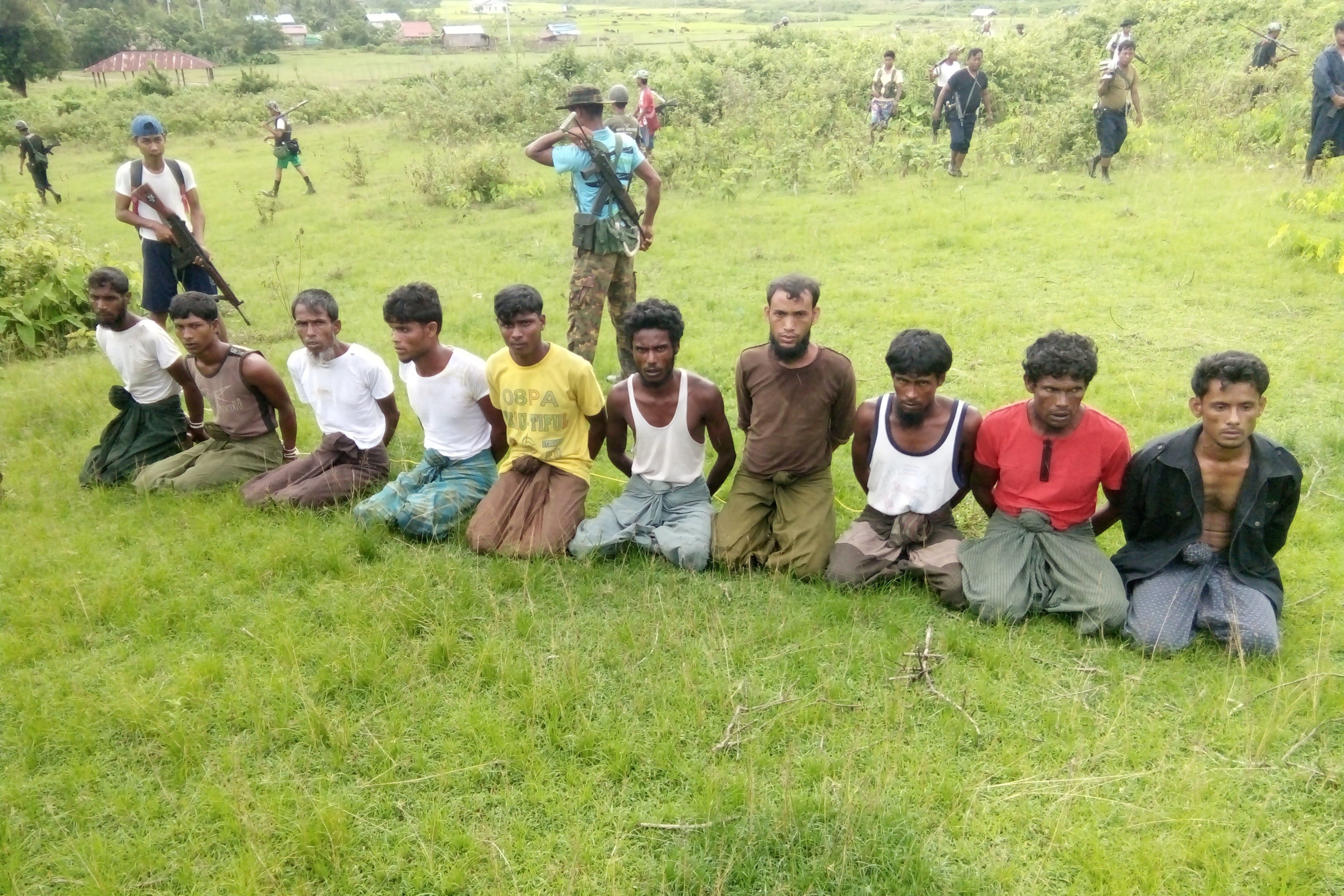 A photograph said to show 10 Rohingya Muslims before their execution in Inn Din village in September. The two Reuters journalists brought the massacre to light. A photograph said to show 10 Rohingya Muslims before their execution in Inn Din village in September. The two Reuters journalists brought the massacre to light.