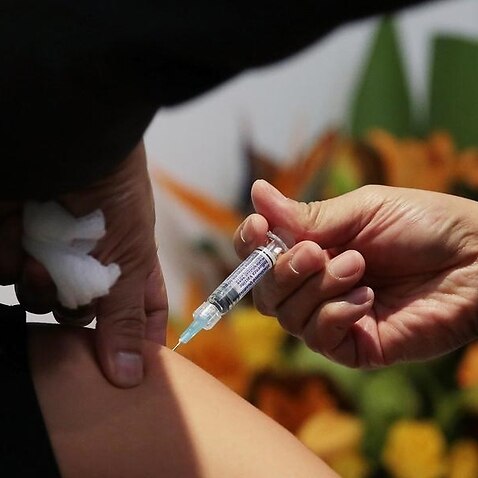 An employee receives a flu shot.