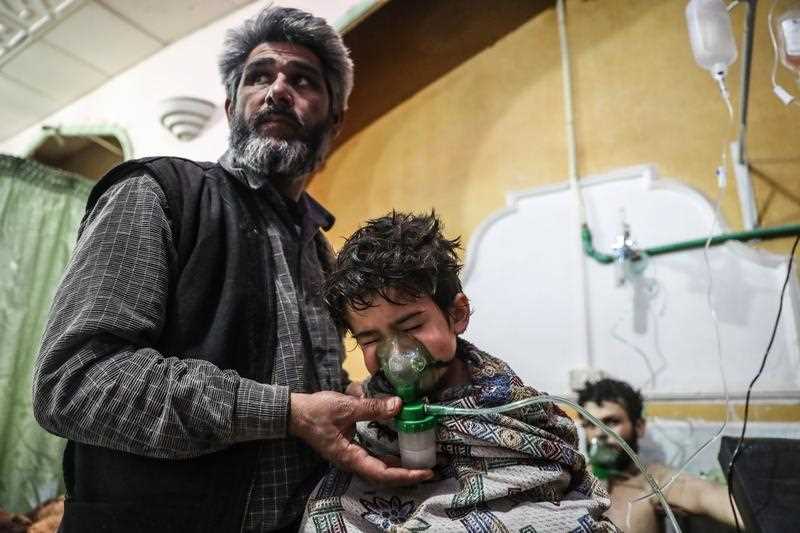 An affected child receives treatment after a gas attack on al-Shifunieh village, in Eastern Ghouta, Syria, 25 February 2018 (issued 26 February 2018).