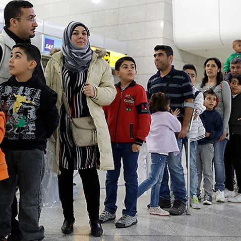Families queueing at the airport