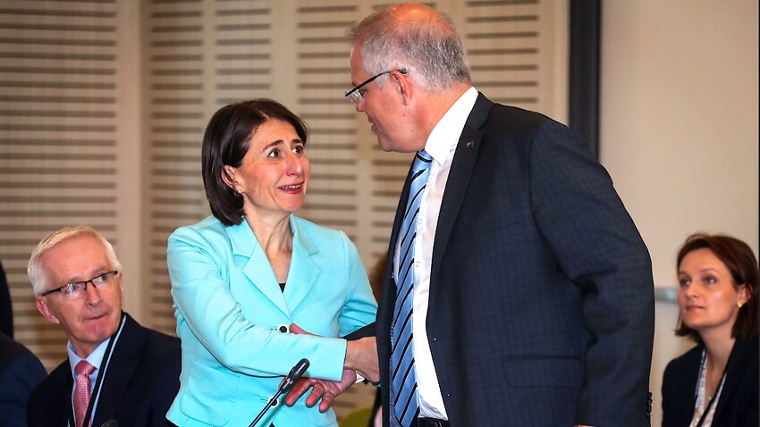 NSW Premier Gladys Berejiklian (left) reacts as Prime Minister Scott Morrison goes to shake her hand.