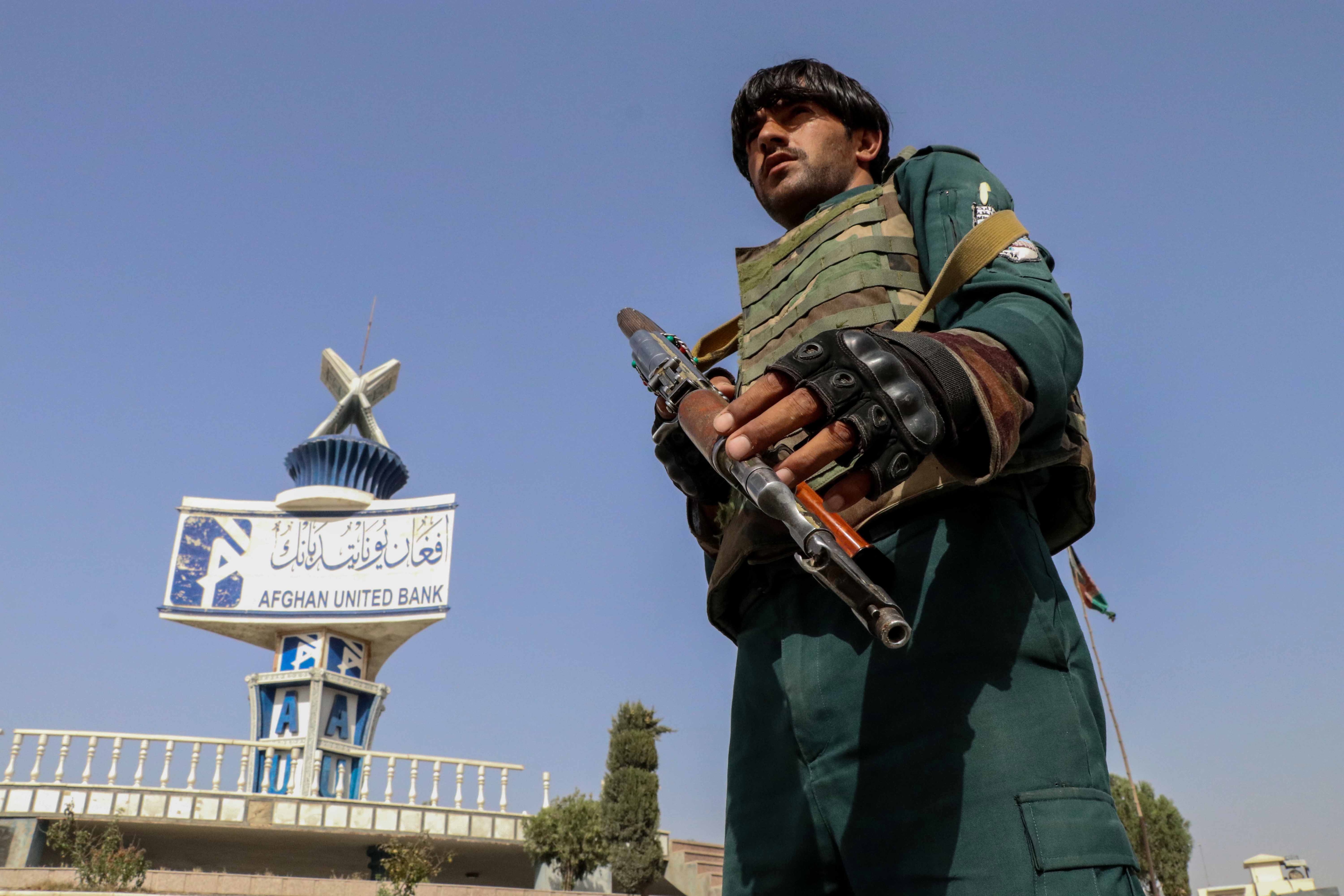 An Afghan security official checks vehicles at a check point in Kandahar, Afghanistan, 12 August 2021.