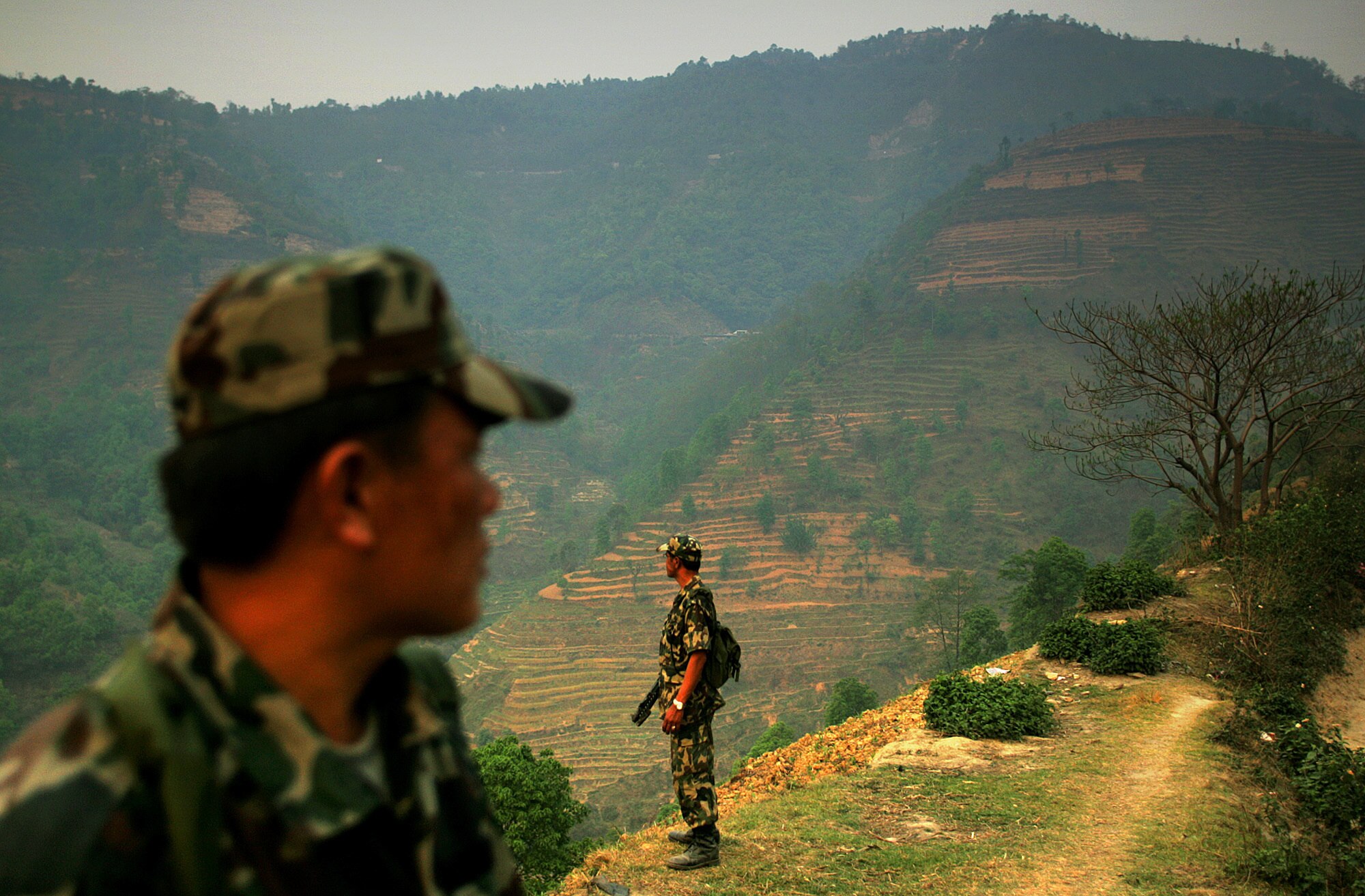 Nepali soldiers patrol a hilltop along a highway west of Kathmandu on the road leading to the border with neighboring India.