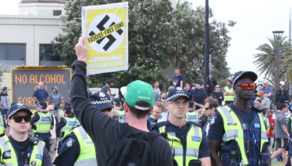 Police watch on as anti-fascist demonstrators gather near a far-right rally on St Kilda foreshore in January 2019.