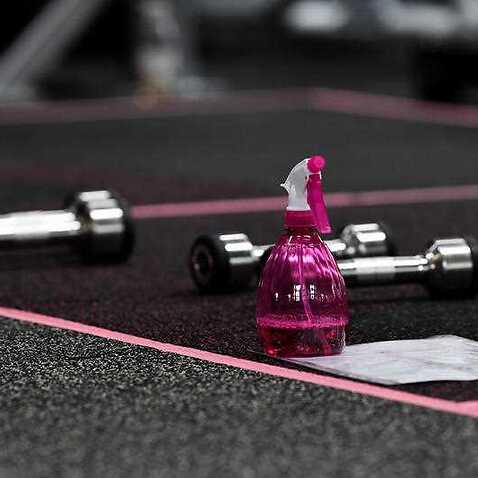 Disinfectant spray is placed around the gym for members to wipe down equipment at a gym in Sydney. 