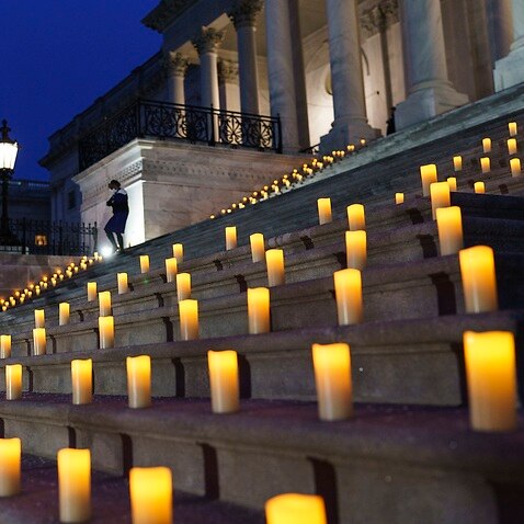 Candles are placed on the steps of the Capitol to mark the anniversary of the insurrection