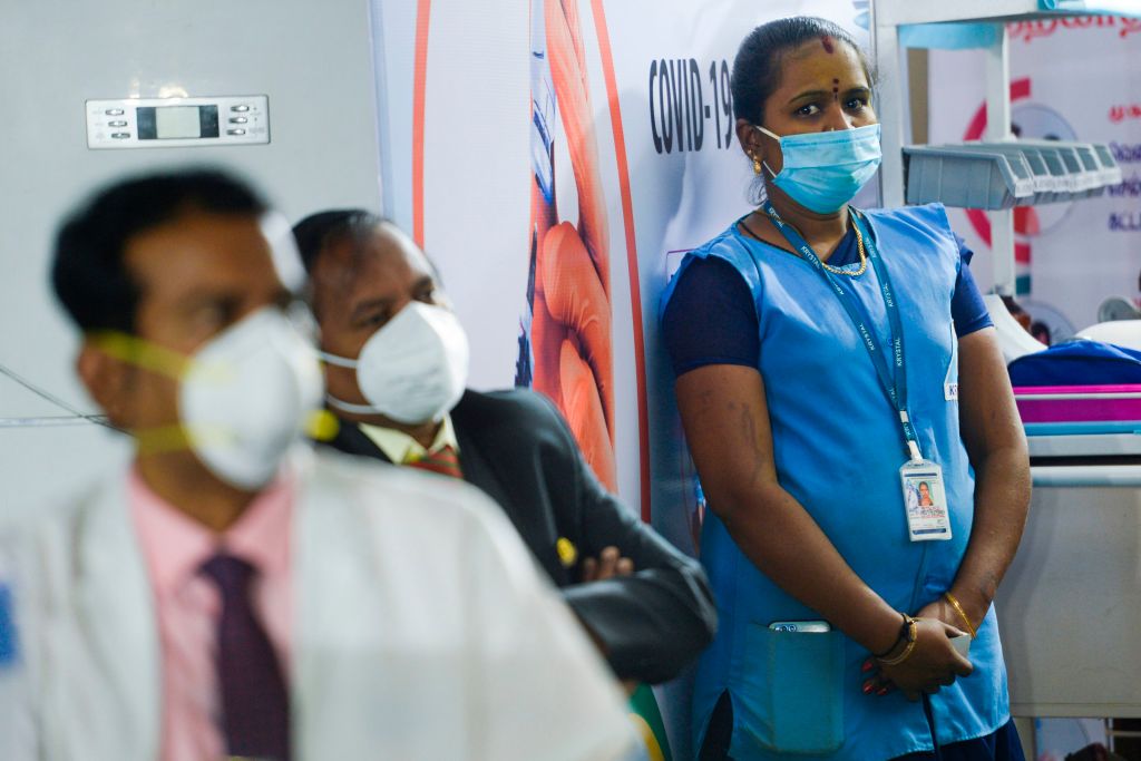 Medical workers wait to be inoculated with a COVID-19 coronavirus vaccine at the government Rajaji hospital in Madurai on 16 January. 