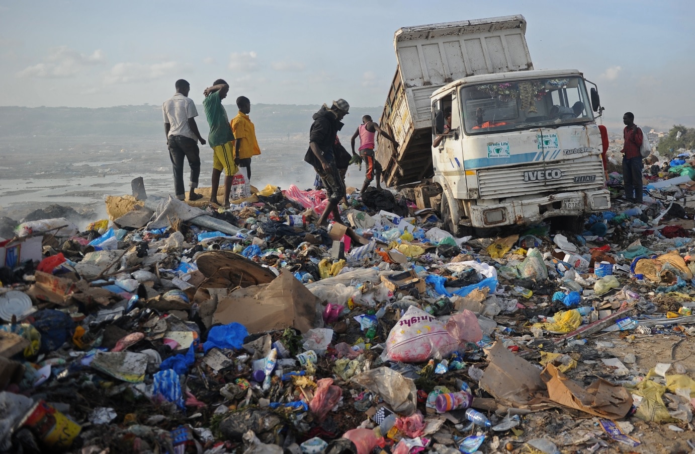   A photo taken on June 2, 2018 shows people searching a garbage dump in Mogadishu, Somalia. 