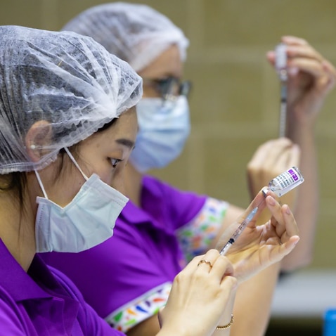 Nurses fill syringes with the COVID-19 AstraZeneca vaccine at the Claremont Showground mass vaccination centre in Perth.