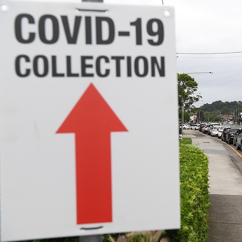 Long lines of people queue for COVID-19 testing at the Figtree Community Centre in Wollongong.