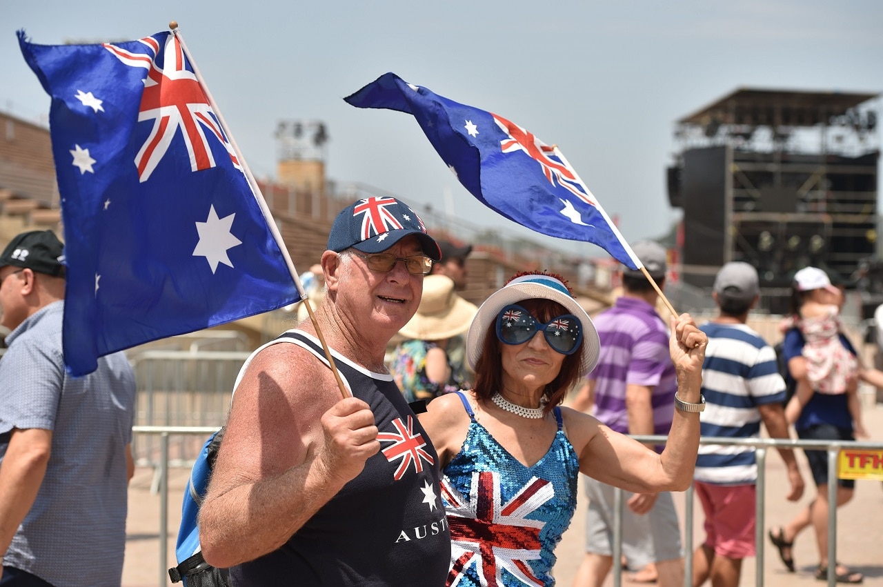 People wave flags to celebrate Australia Day. People wave flags to celebrate Australia Day.
