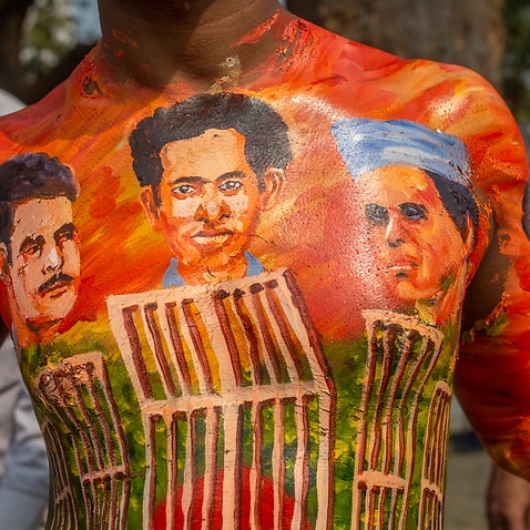 A man has his body painted with the portraits of the martyrs of the Bengali Language Movement demonstrations of 1952 during International Mother Language Day.
