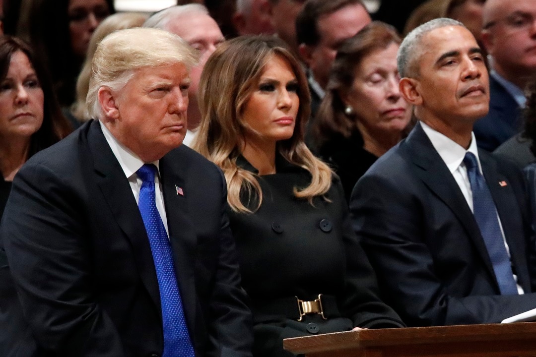 President Donald Trump, first lady Melania Trump and former President Barack Obama sit side-by-side at the former president's funeral.