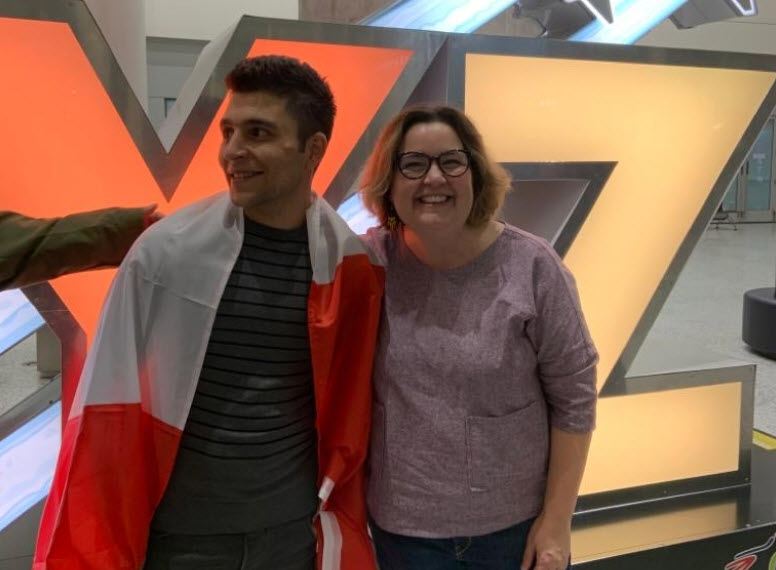 Laura Beth Bugg (R) welcomes ex-Manus detainee Amir Sahragard at a Toronto airport