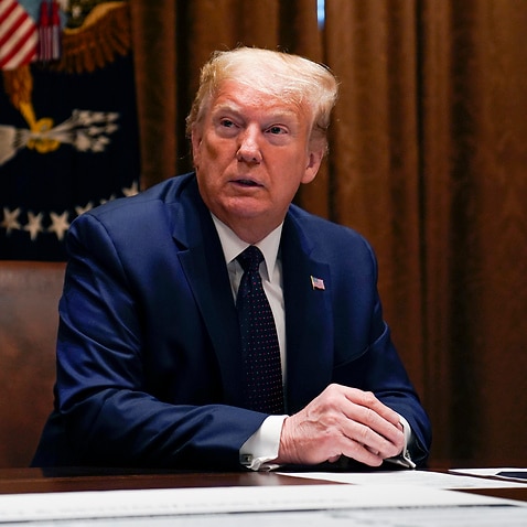 President Donald Trump listens during a meeting with Sen. Tim Scott, R-S.C., to talk about opportunity zones in the Cabinet Room of the White House, Monday, May 18, 2020, in Washington. (AP Photo/Evan Vucci)