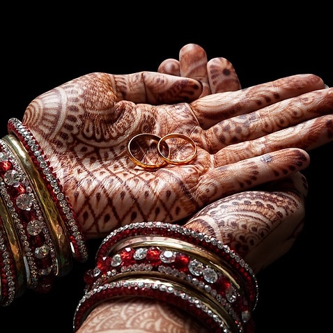 Representational image of an Indian bride having henna tatoo on her hand before the wedding.