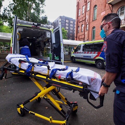 Paramedics tending to their ambulance outside St Vincent hospital in Melbourne.
