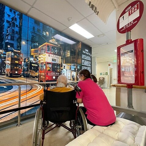Residents at Elderly Chinese Home enjoy sitting at the bus stop.