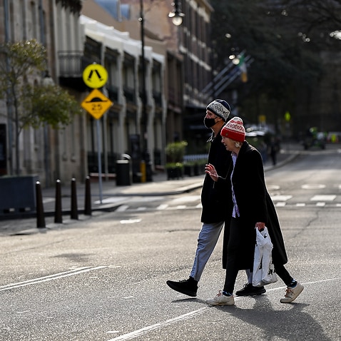 People cross an empty street in The Rocks, Sydney, Thursday, July 8, 2021. NSW has recorded 38 new locally acquired COVID-19 cases overnight, the highest daily number of new cases in 14 months. (AAP Image/Bianca De Marchi) NO ARCHIVING
