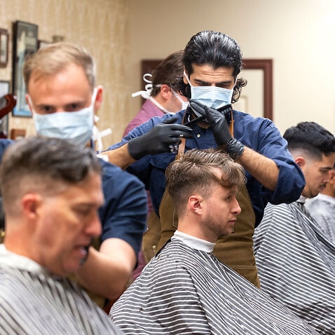 Barbers at gives haircuts to customers at The French Barber on May 14, 2020 in Wellington