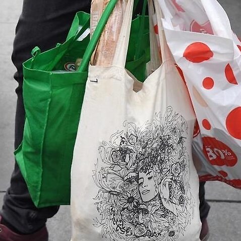 Picture of a shopper is seen carrying bags at a Coles Sydney.