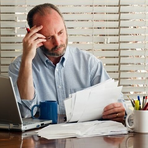 Middle Aged Male Homeowner Struggles With Paying Bills
