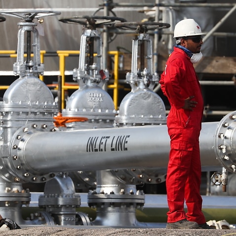 A worker at an oil processing facility of Saudi Aramco, a Saudi Arabian state-owned oil and gas company, at the Abqaiq oil field.