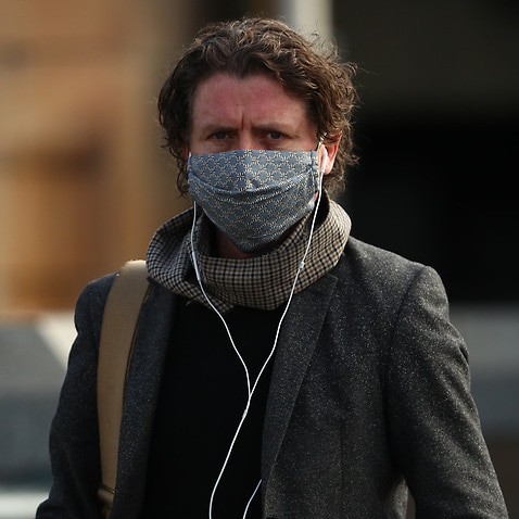 A pedestrian wears a mask in Melbourne on Thursday. 