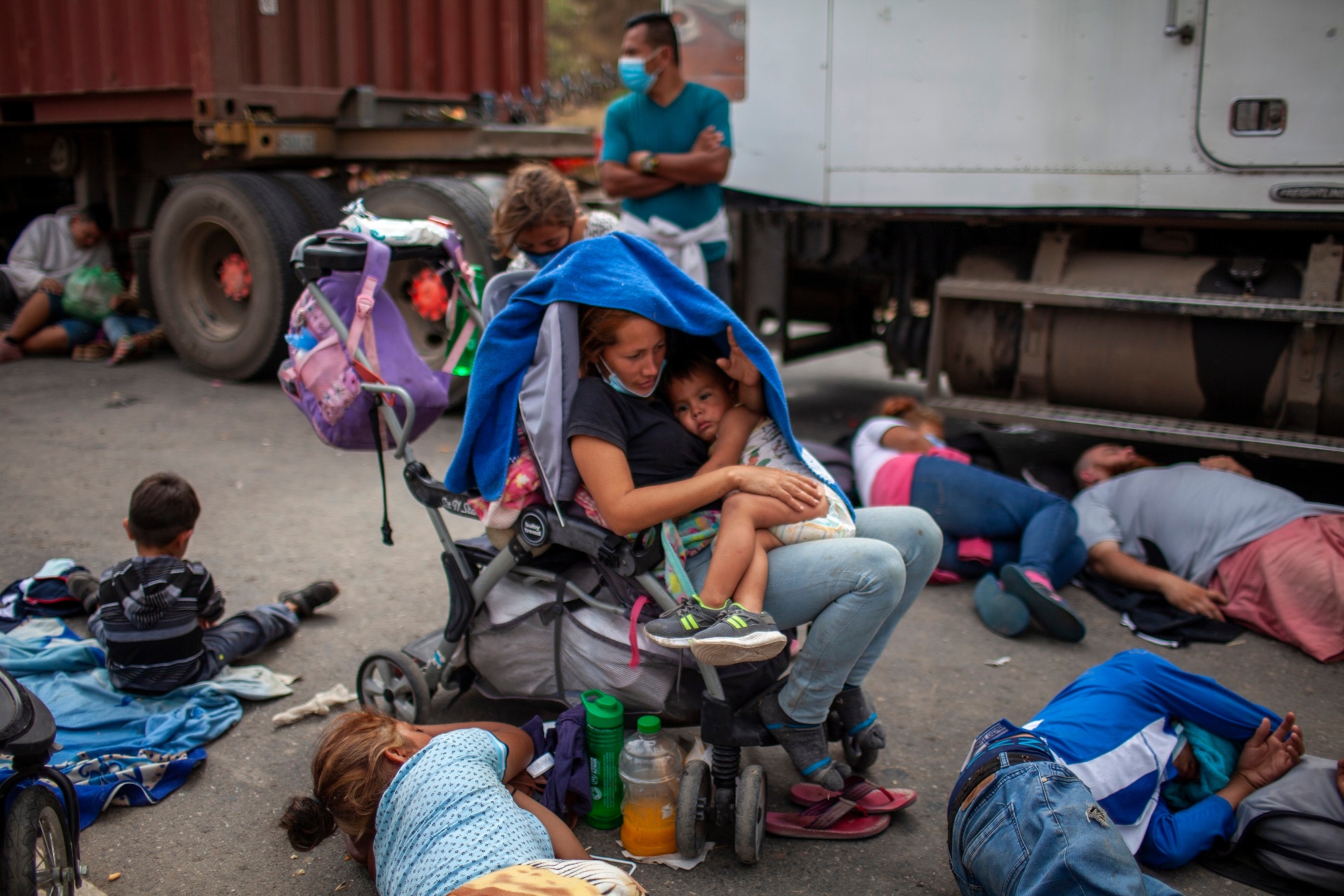 Honduran asylum seekers gather in front of a police line blocking a highway in Vado Hondo, Guatemala.