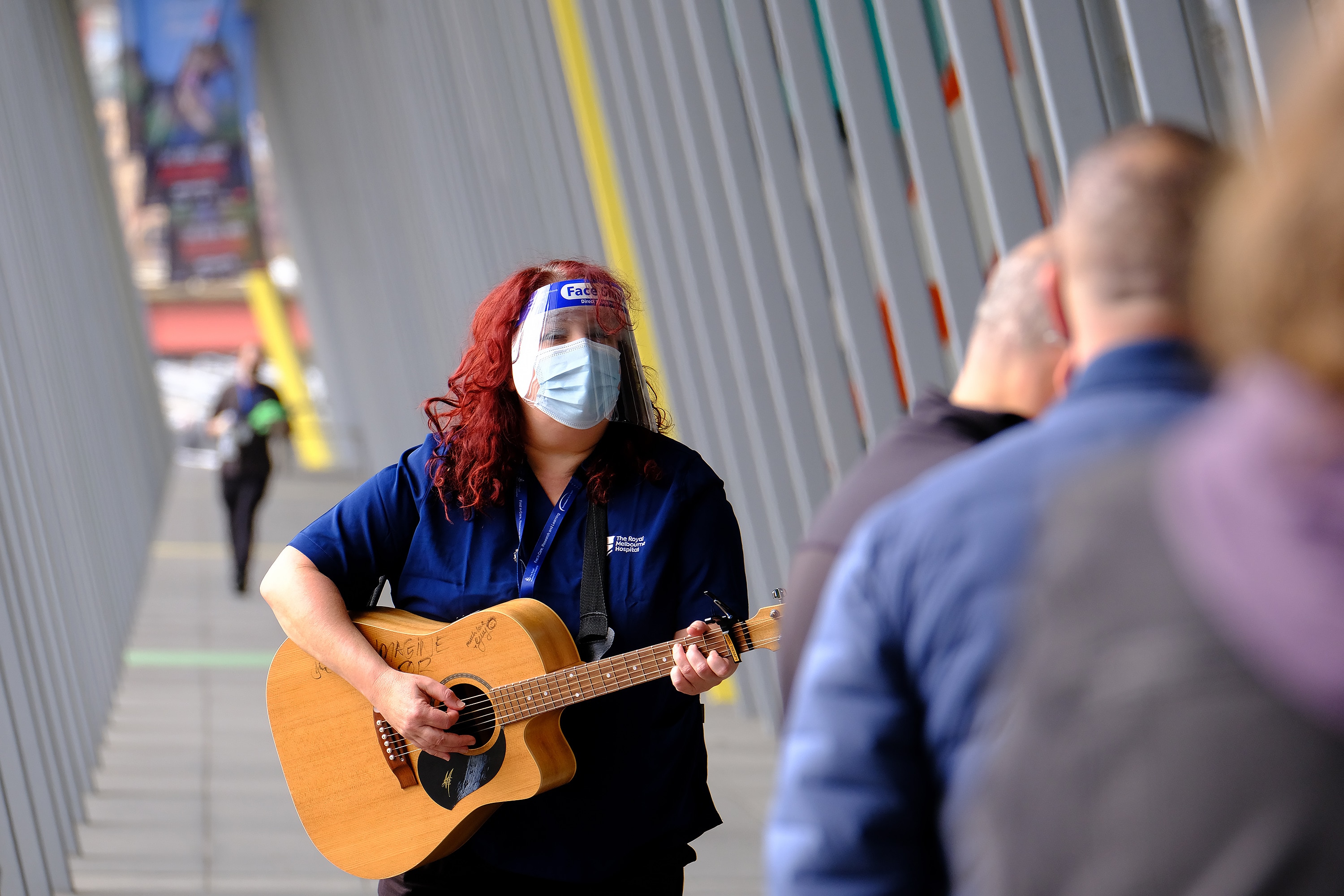 The Royal Melbourne Hospital's music therapy team were outside the Melbourne Convention and Exhibition Centre hub on Friday