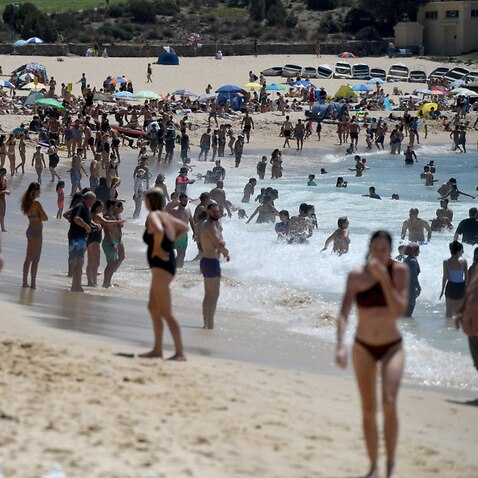 Beachgoers are seen at Coogee Beach during hot weather in Sydney, Saturday, 1 February, 2020.