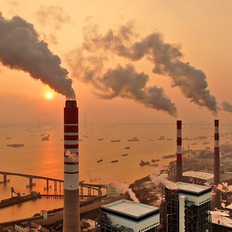 The sun sets near a coal-fired power plant on the Yangtze River in Nantong in eastern China's Jiangsu province