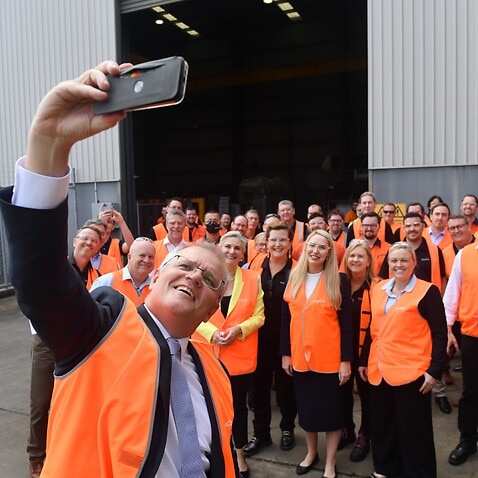 Prime Minister Scott Morrison takes a selfie with workers at an engineering facility specialising in renewable technology during a visit to the Hunter Valley, Monday, November 8, 2021. (AAP Image/Mick Tsikas) NO ARCHIVING