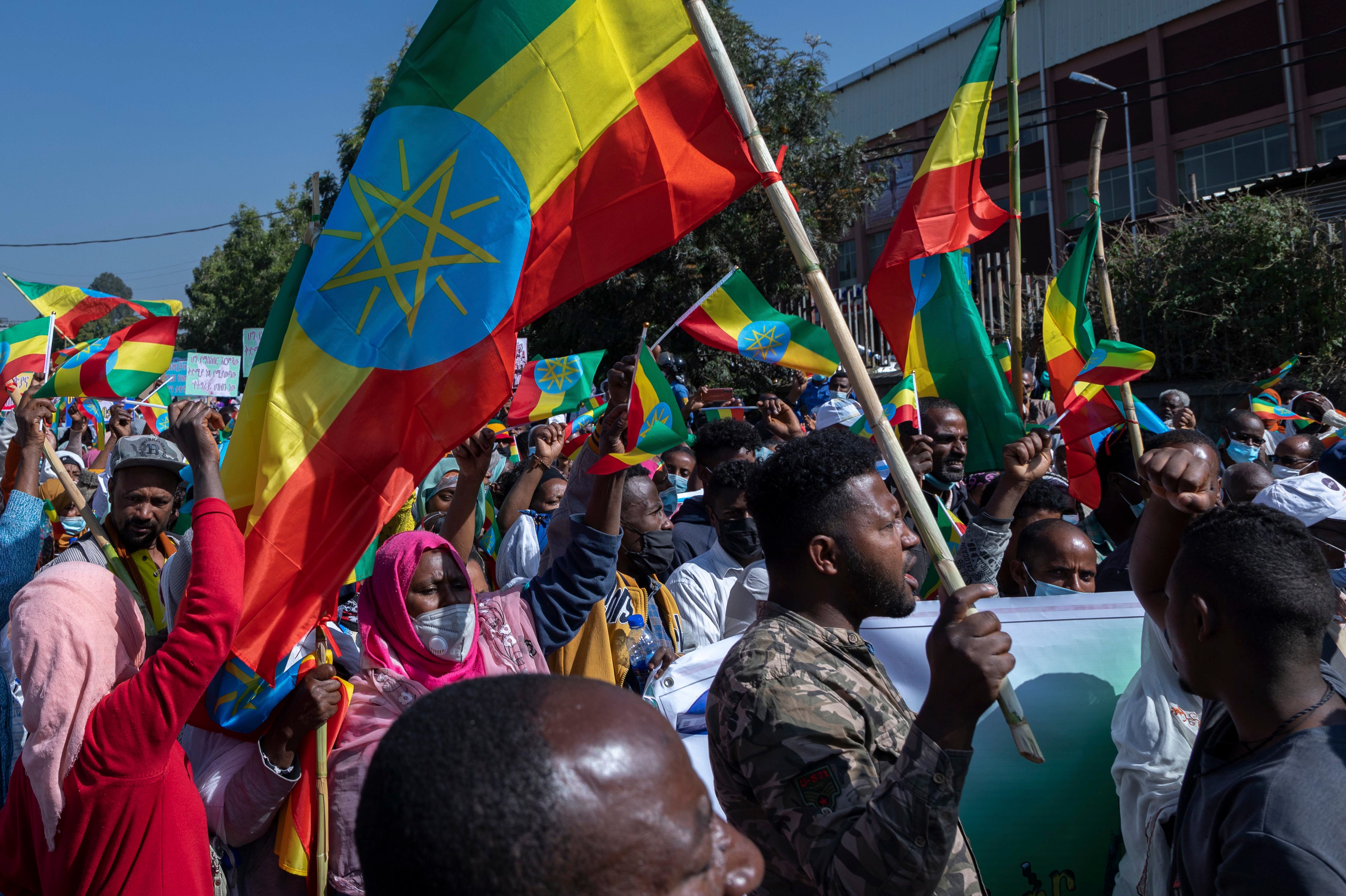 Ethiopians hold national flags as they gather at an event organised by city officials to honour the Ethiopian military