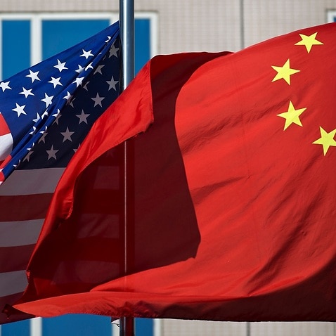In this Sept. 5, 2012, file photo, U.S. and China's national flags flutter in winds at a hotel in Beijing. 