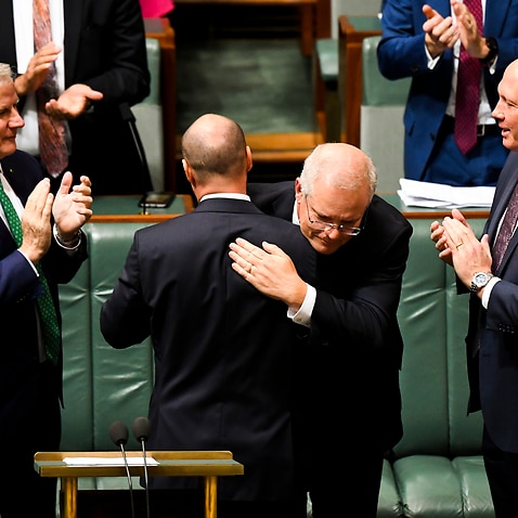 Australian Prime Minister Scott Morrison congratulates Australian Treasurer Josh Frydenberg after handing down his third Federal Budget, Tuesday, May 11, 2021.