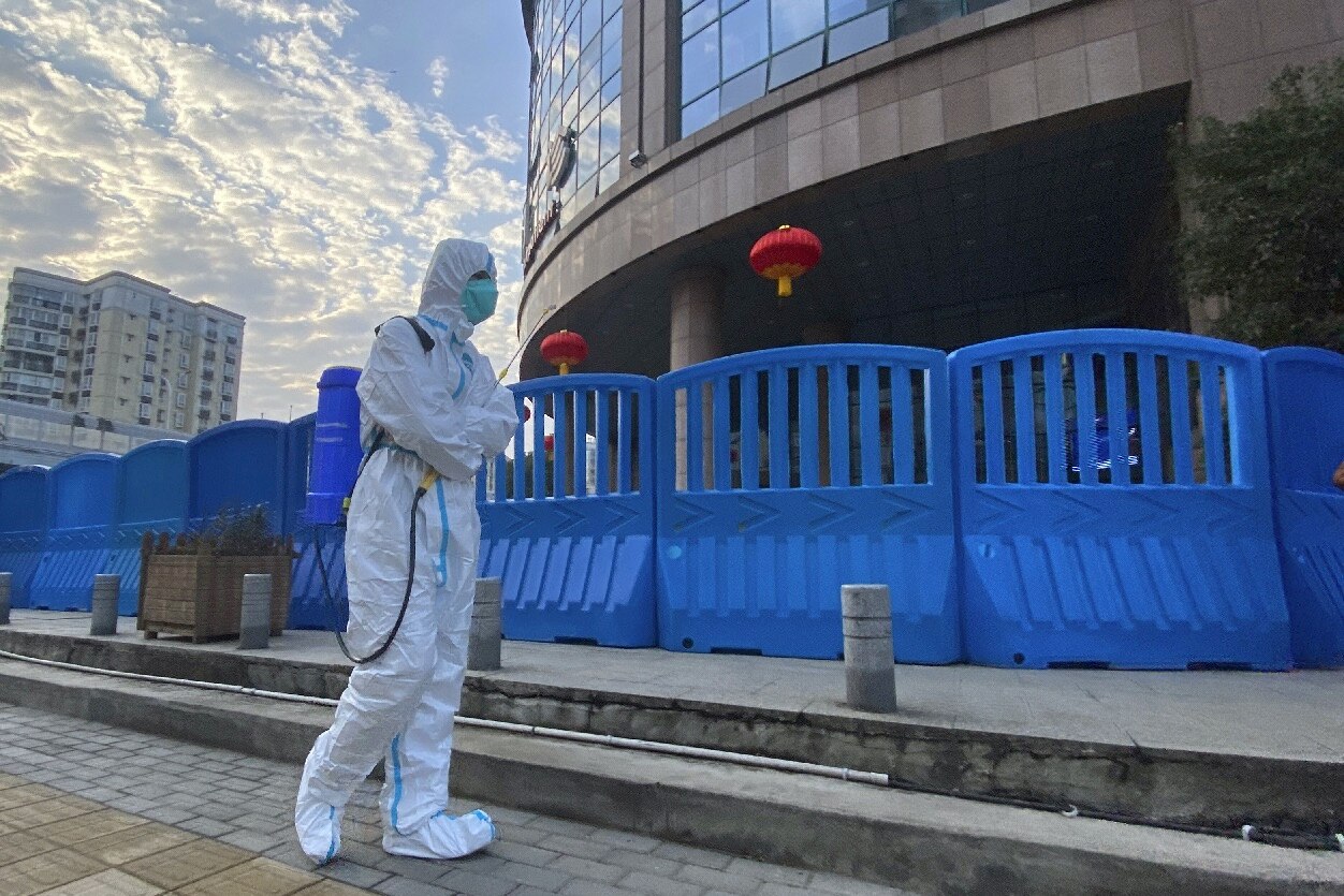 A worker with disinfecting equipment walks outside the Wuhan Central Hospital on 6 February 2021.