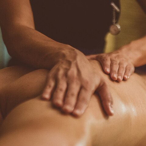 A masseuse working on a client 