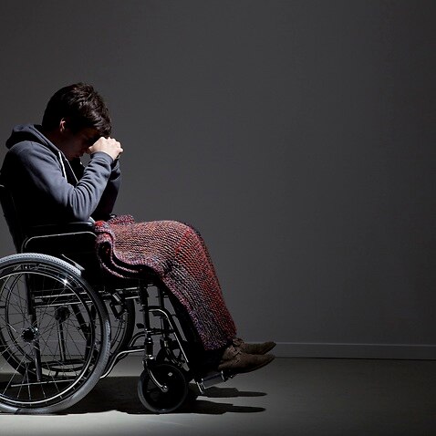 Frustrated Caucasian man in wheelchair