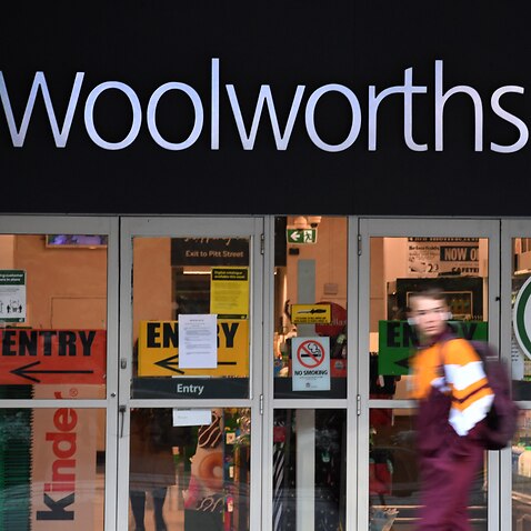 A pedestrian passes a Woolworths supermarket in Sydney in April.