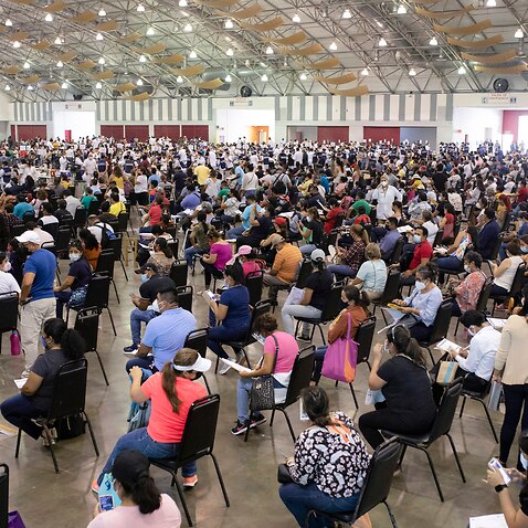 Education workers wait for COVID vaccination in Mexico.