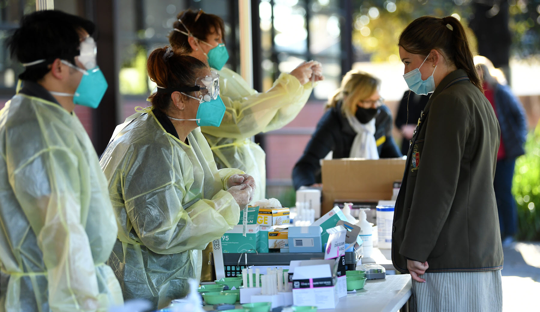 High school students receive rapid antigen tests in Melbourne. 