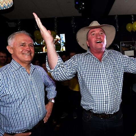 Malcolm Turnbull celebrates with Barnaby Joyce after his by-election win in New England last year. 