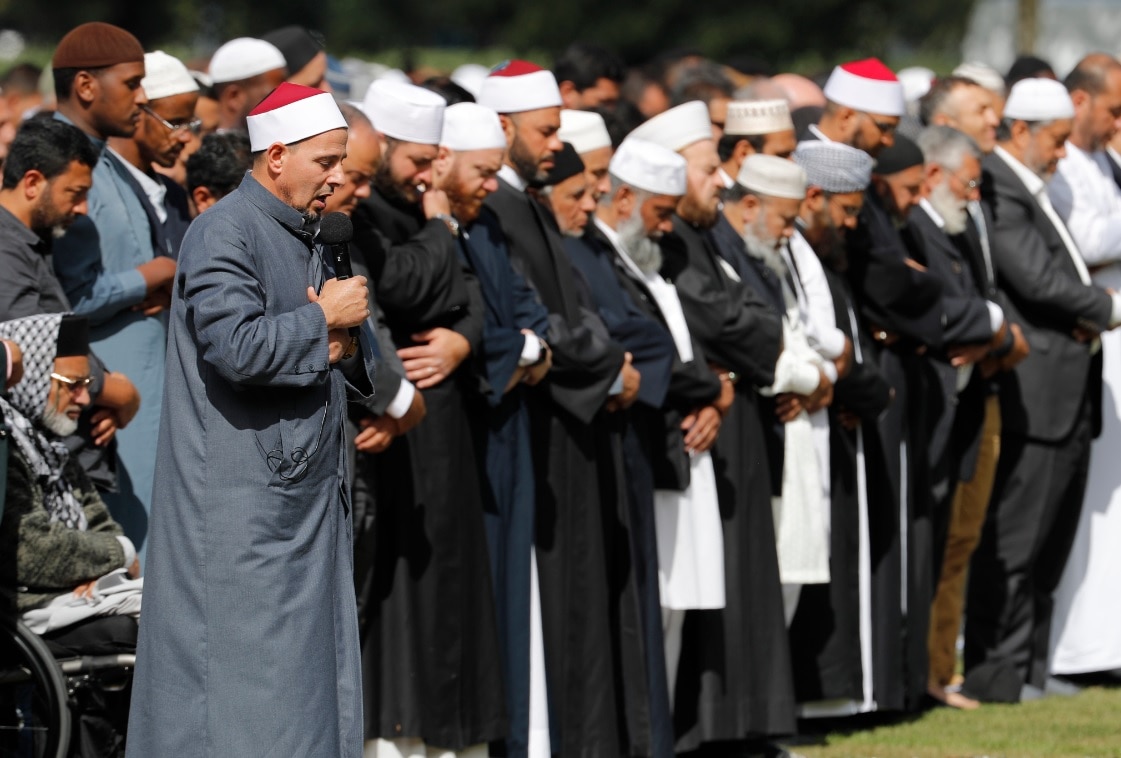 Imam Gamal Fouda, holding microphone, leads Friday prayers at Hagley Park in Christchurch, New Zealand, Friday, March 22, 2019.