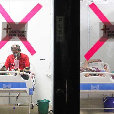 COVID-19-infected patients are seen inside a care facility  in New Delhi.