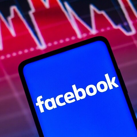 In this photo illustration the Facebook logo seen displayed on a smartphone screen, with graphic representation of the stock market in the background. (Photo by Rafael Henrique / SOPA Images/Sipa USA)