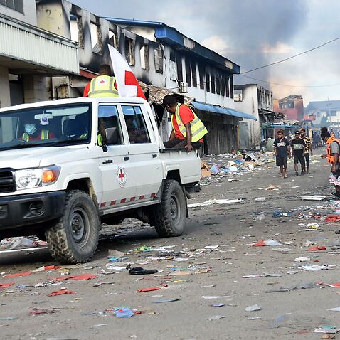A Red Cross vehicle passes through the Chinatown district of Honiara on the Solomon Islands on 26 November, 2021.
