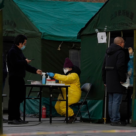 Residents line up for coronavirus tests at tents set up on the streets of Beijing.