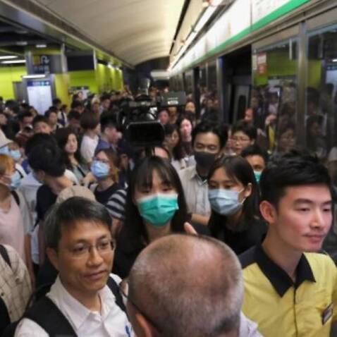 Anti-extradition bill demonstrators block an MTR train in Hong Kong.